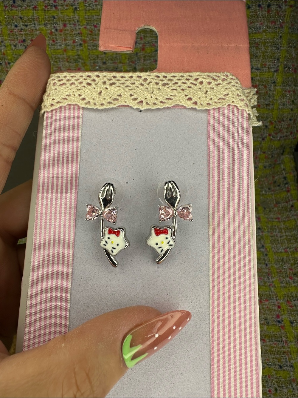 A great Hello Kitty Silver Tone Earrings with White Enamel Faces and Pink Bows